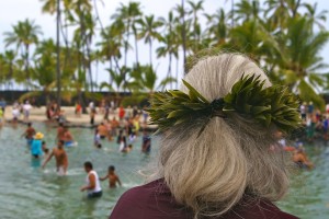woman watches the Puuhonua o Honaunau hukilau