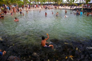 boy shows off caught fish at Puuhonua o Honaunau