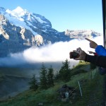 people on train look up at mountains