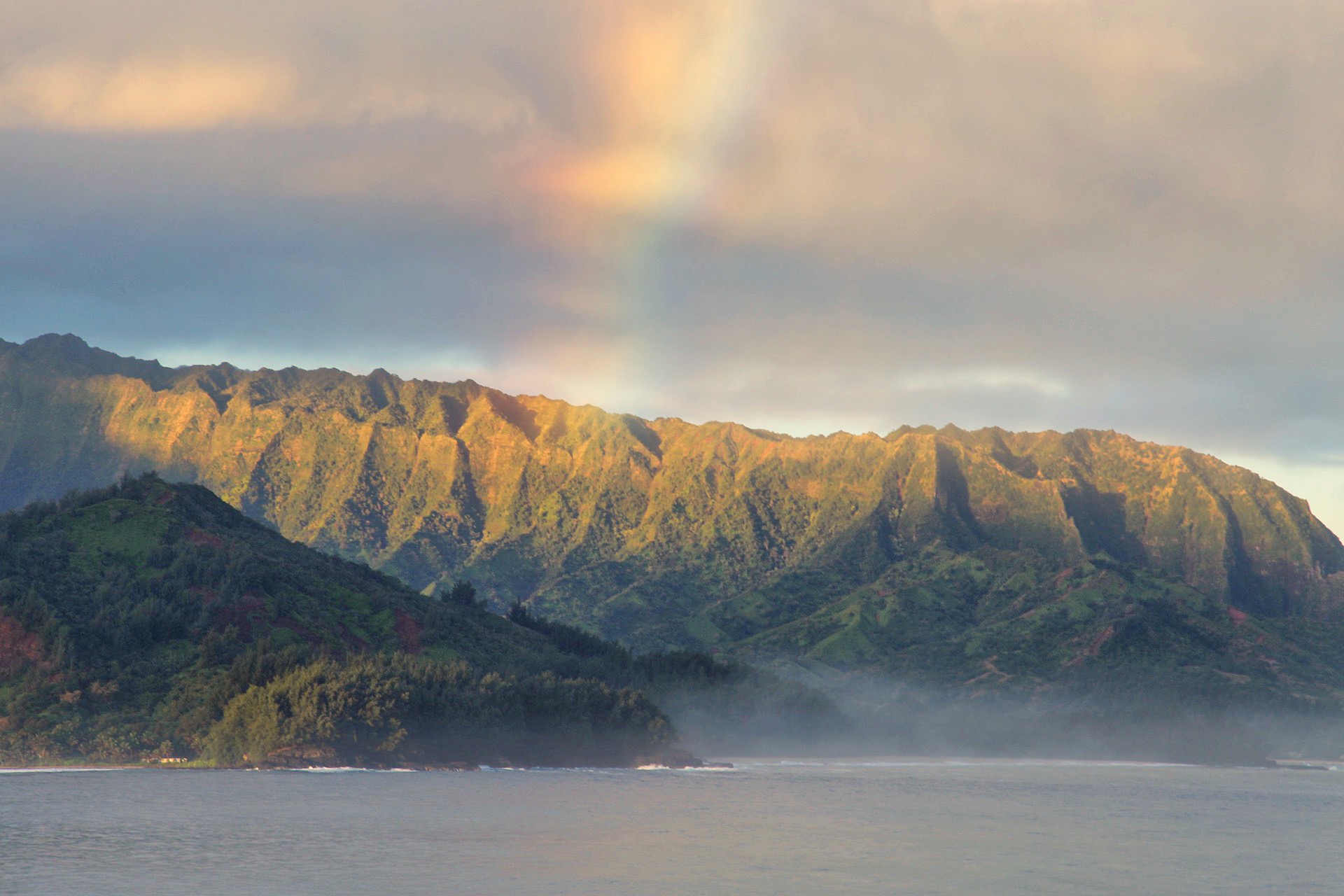 rainbow over cliffs kauai hawaii
